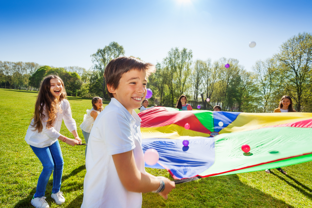 Stock image of children playing with parachute